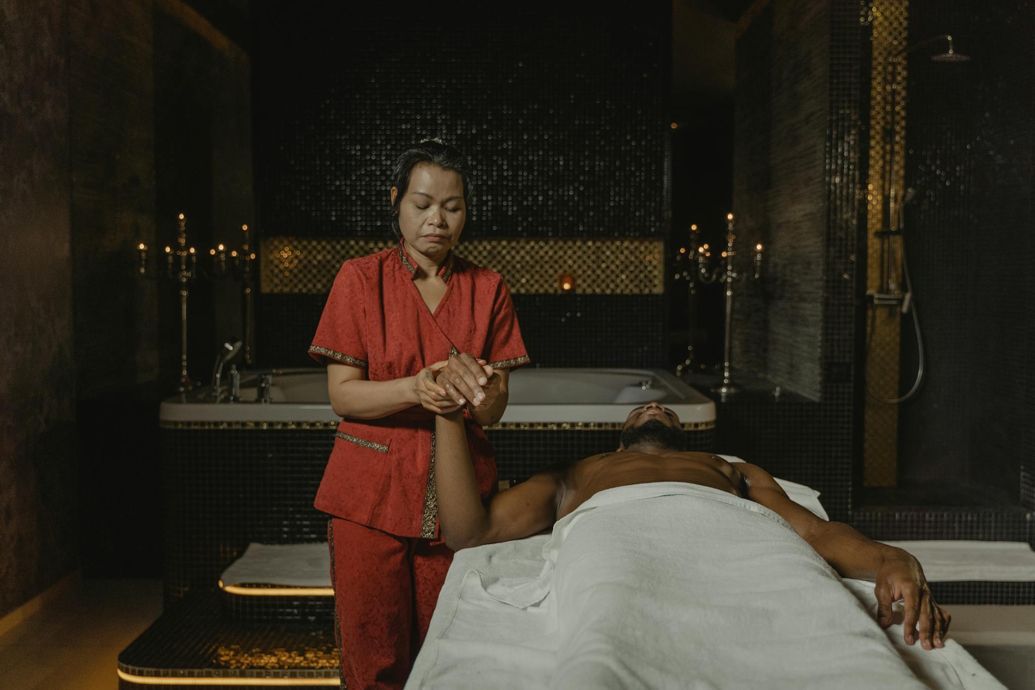 A serene spa therapy session featuring a masseuse providing a relaxing massage treatment to a client.