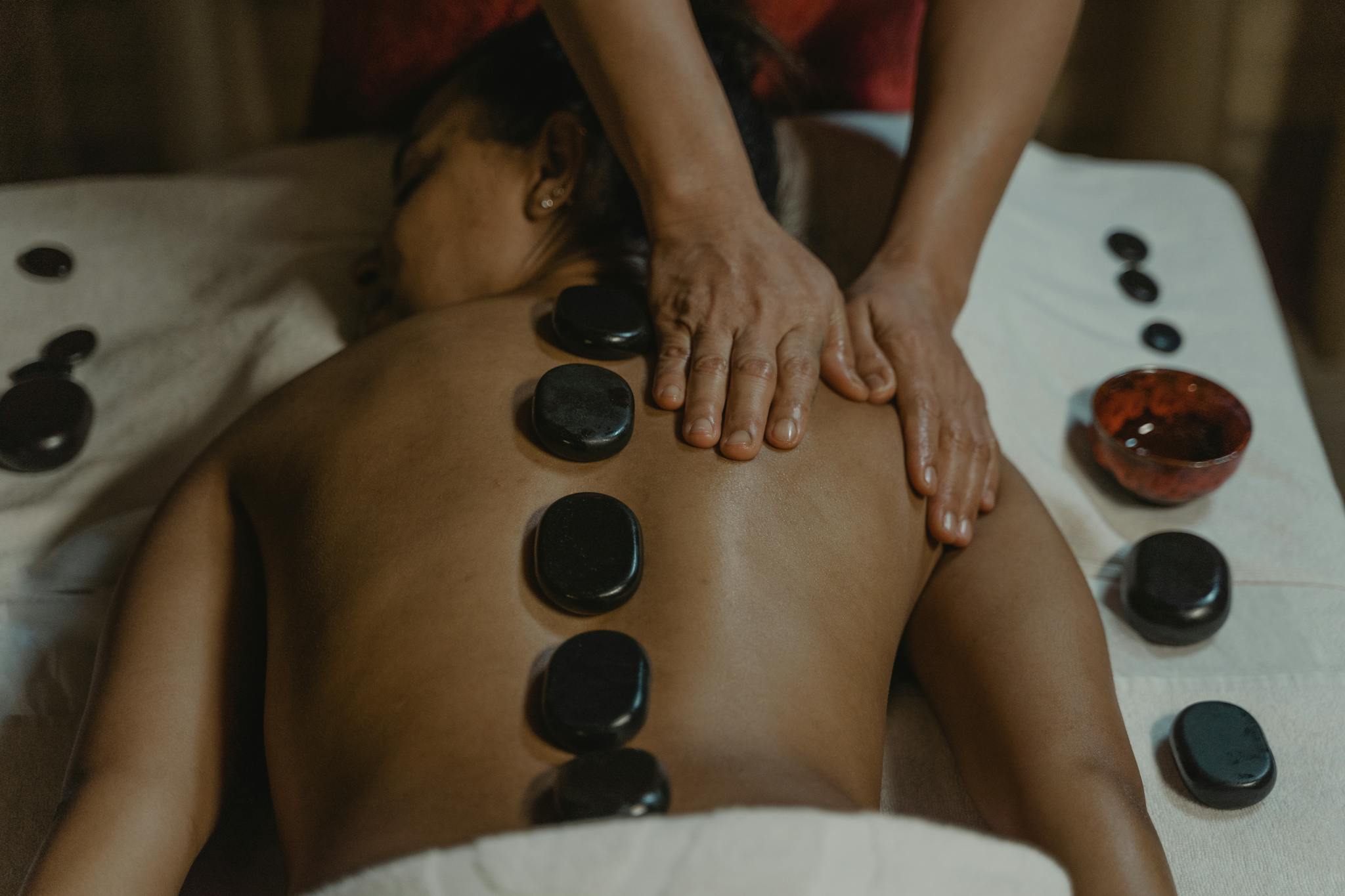 Experience ultimate relaxation with a rejuvenating hot stone massage enhancing well-being.